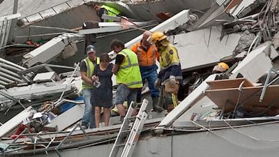 Rescue workers pull people out of a building damaged by Tuesday's earthquake in Christchurch.