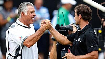 Australia's Adam Scott, right, celebrates with caddie Steve Williams on the 18th green after Scott won the WGC-Bridgestone Invitational tournament in Akron, Ohio.