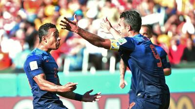 Memphis Depay, left, celebrates with Robin van Persie after scoring the Netherlands' third goal on Wednesday in 2014 World Cup Group B play in Porto Alegre, Brazil. Damien Meyer / AFP