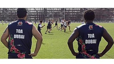 The Toa Dubai players Sol Makdaad, from Lebanon, and Saidi Kipyego, from Kenya, watch their teammates play in yesterday's tournament.