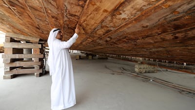 Majid Obeid Bin Suloom Al Falasi inspects the hull during construction in the summer of 2018. Chris Whiteoak / The National