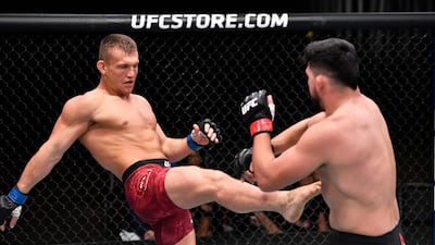 Ian Heinisch, left, kicks Kelvin Gastelum in their middleweight fight during the UFC 258 event at UFC APEX in Las Vegas, Nevada. Jeff Bottari / Zuffa LLC / UFC
