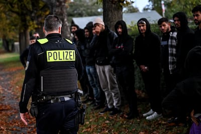 Migrants stand in line after being detained by German police on the Polish border in October 2023. EPA