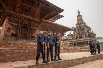 Nepalese police stand guard at Patan Durbar Square during celebrations of the Holi festival amid coronavirus restrictions in Kathmandu, Nepal. EPA