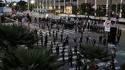 Police officers enforce a curfew during a protest in Los Angeles, California. AFP