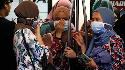 Passengers wear masks to prevent the outbreak of a new coronavirus in a Light Rail Transit train in Kuala Lumpur, Malaysia. Reuters