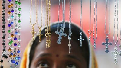 A woman looks at religious lockets at a stall outside a church during the Christmas celebrations in Chandigarh, India, on December 25, 2017. Ajay Verma / Reuters