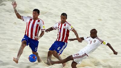 The UAE, in white, defeated Paraguay to boost their chances of reaching the Fifa Beach Soccer World Cup quarter-finals. Manuel Queimadelos / Beach Soccer World Cup
