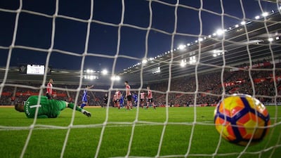 Diego Costa of Chelsea, back, scores past Fraser Forster of Southampton for the second goal. Clive Rose / Getty Images