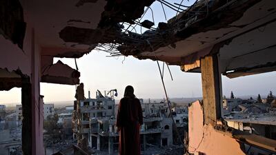 Hidya Atash looks at the destruction of Shujaia from the top floor of her home, which was hit in July last year by a warning rocket. The family of 40 fled. Photos Heidi Levine for The National