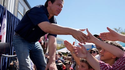 Florida Governor Ron DeSantis shakes hands with fairgoers. AP