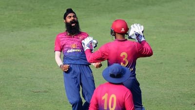 UAE's Simranjeet Singh celebrates the wicket of USA's Shayan Jahangir