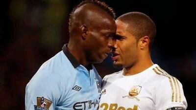 Mario Balotelli, left, came on at half time for Manchester City, and squared up to Swansea City captain Ashley Williams after the Italy striker felt he was pulled back in the area. Phil Noble / Reuters