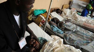 A priest holds a rape victim as they pray at a clinic in Goma.