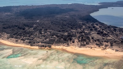 Volcanic ash covers roof tops and vegetation in an area of Tonga on January 17, days after a huge undersea volcanic eruption and tsunami struck. AP