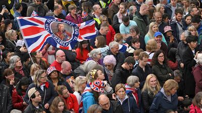 Well-wishers line the route of the coronation procession. AP