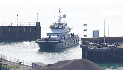 A lifeboat brings migrants to the port of Dover at England's southern tip. Many Afghans have crossed the Channel on small boats amid what charities say is a lack of legal routes. PA