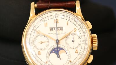An exhibitor shows a watch by Patek Philippe for King Farouk of Egypt during Christie's exhibition in Dubai. The watch maker may come up for sale. EPA