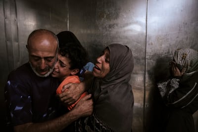 Palestinians mourn relatives killed by the Israeli military, at Al Shifa Hospital morgue, Gaza city. AP