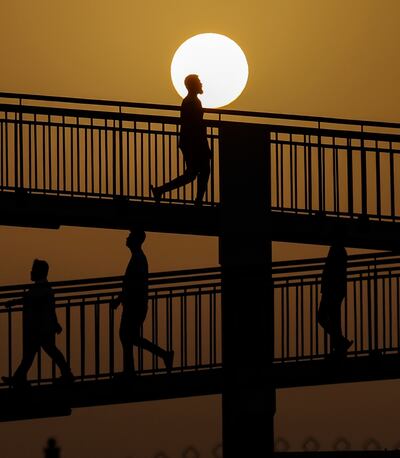 Workers head to Ras Al Khor fruit and vegetable market in Dubai. People working outdoors in the UAE take a rest break during the hottest hours of summer days. EPA