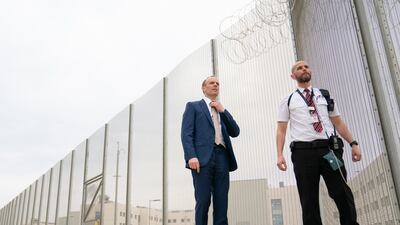 Deputy Prime Minister and Justice Secretary Dominic Raab, left, with a prison officer at the opening of category C prison HMP Five Wells in Wellingborough. PA