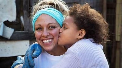 Geraldine Hafez, an Egyptian who studied at the American University of Sharjah, with one of the grateful favela children. Courtesy Amelia Johnson