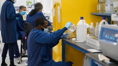 A scientist pours a solution into a beaker at Mako Medical Laboratories. Willy Lowry / The National