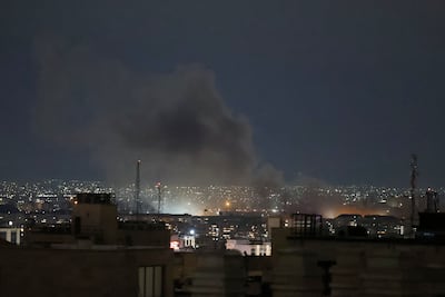 A plume of smoke rises from the site of a strike in Tehran. AFP