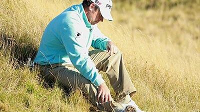 Lee Westwood, pictured feeling his injured calf, is poised to become world No 1.