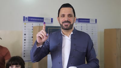 Shaswar Abdulwahid, head of the New Generation Movement, shows his inked finger after voting in Sulaimaniyah in 2021. AFP
