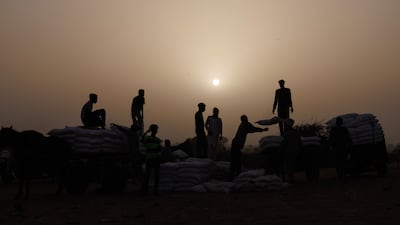 Flour is loaded on to carts near the border between Sudan and Chad. The Sudanese civil war has raged for almost three years. Getty Images
