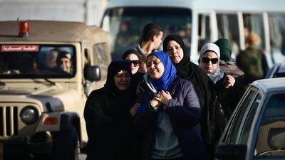 Egyptian relatives of security force members who were killed in North Sinai province during an attack the day before, arrive crying at Al Maza military airport where the bodies had been flown on January 30 in Cairo. AFP Photo