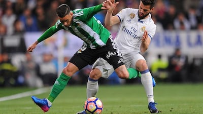 Antonio Sanabria of Real Betis tackles Nacho of Real Madrid. Denis Doyle / Getty Images