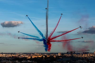 Aircrafts of the Patrouille de France fly over Paris during a parade at the Champs-Elysees for all the French athletes who participated in the 2024 Olympics and Paralympics. Reuters