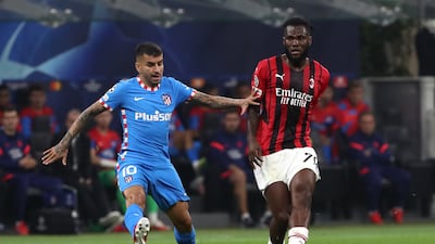 Franck Kessie of AC Milan passes the ball whilst under pressure from Angel Correa of Atletico Madrid. Getty Images