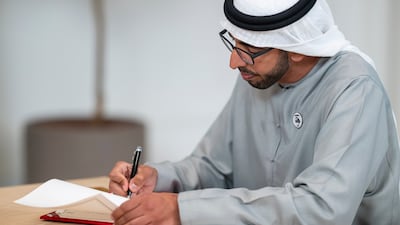 Minister of State Sheikh Shakhbout bin Nayhan puts pen to paper