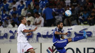 Al Nasr's Ahmed Al Yassi, right, tries to control the ball as Lokomotiv's Temurkhuja Abdukholikov watches on during their Asian Champions League Group A football match Karim Sahib / AFP
