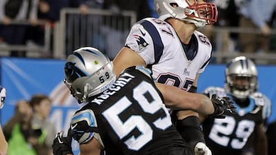 Luke Kuechly blocks Rob Gronkowski on Monday night. Originally called a defensive pass interference penalty on the game's final play, officials later determined the ball thrown to Gronkowski was uncatchable and the flag was waved off. Chuck Burton / AP