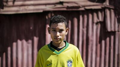 Jose Garcia, 13, wearing the jersey of the Brazilian national team, poses for pictures at a multisport park in “10 de Junio” neighbourhood, in Managua, on January 16, 2016. Football is gaining enthusiasts in Nicaragua where baseball has been historically dominant but is now giving way to the new sport, analysts said. Inti Ocon / AFP