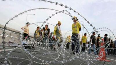 Anti-government protesters stand at a barrier during rally at Bangkok's Suvarnabhumi Airport on Nov 26 2008.