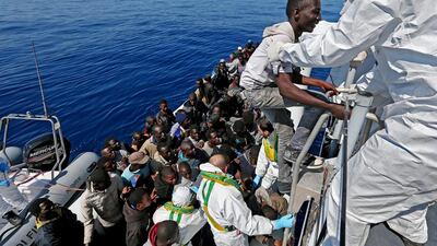 Illegal migrants from a group of 200 people are pictured being rescued by the Italian Guardia di Finanza boat 'Denaro' in the Mediterranean Sea on April 22, 2015. Alessandro Di Meo/EPA