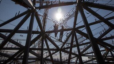 Men work on Louvre Abu Dhabi's dome in January 2015. Silvia Razgova / The National