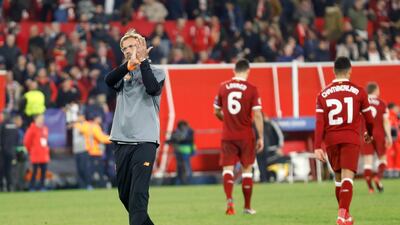 Jurgen Klopp applauds Liverpool's travelling supporters as the players leave the pitch at the end of their 3-3 draw against Sevilla in their Champions League group game at the Ramon Sanchez Pizjuan. Miguel Morenatti / AP Photo