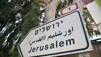 A road sign to Jerusalem reads "Yerushalayim" in Hebraic script on top with "Yerushalayim (al-Quds)" in Arabic below it and the English spelling at the bottom.