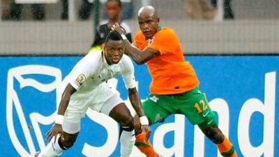Ghana's Samuel Inkoom defends against Zambia's James Chamanga.