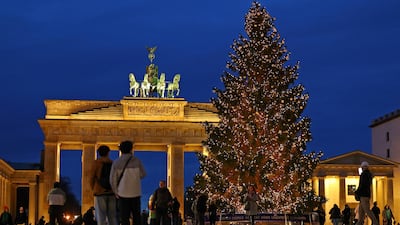 A Christmas tree shines in front of the Brandenburg Gate in Berlin. Germany's capital and eastern federal states remain underserved in terms of flight connectivity. Reuters