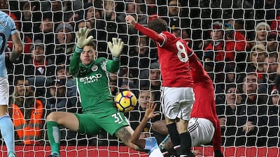 Manchester City goalkeeper Ederson makes a double save from Manchester United's Zlatan Ibrahimovic, right, and Juan Mata during the Premier League match at Old Trafford. City won the match 2-1. Reports on Monday said Ederson was involved in a confrontation with United manager Jose Mourinho after the game in the dressing room area. Nigel Roddis / EPA