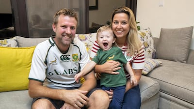 Rival couple Sarah and James Greenwood debate which team jersey their two-year-old son Sebastian should wear. Antonie Robertson / The National