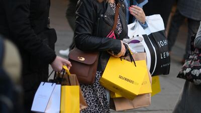 Shoppers carry purchases in Selfridges bags on Black Friday in central London, November 25. AFP