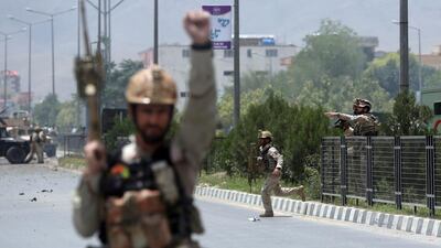 Afghan security forces run at the site of a suicide attack during clashes with Taliban fighters in front of the Parliament, in Kabul, Afghanistan. Massoud Hossaini / AP Photo